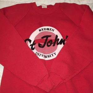 A red “Redman University” sweater